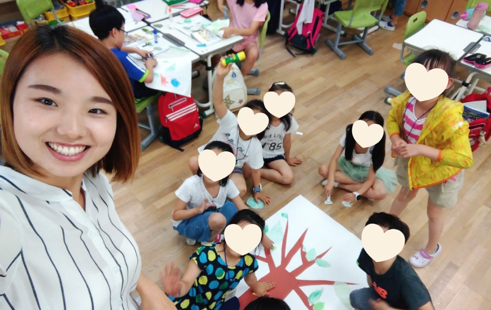 Boram teaching a group of children an art activity in her classroom